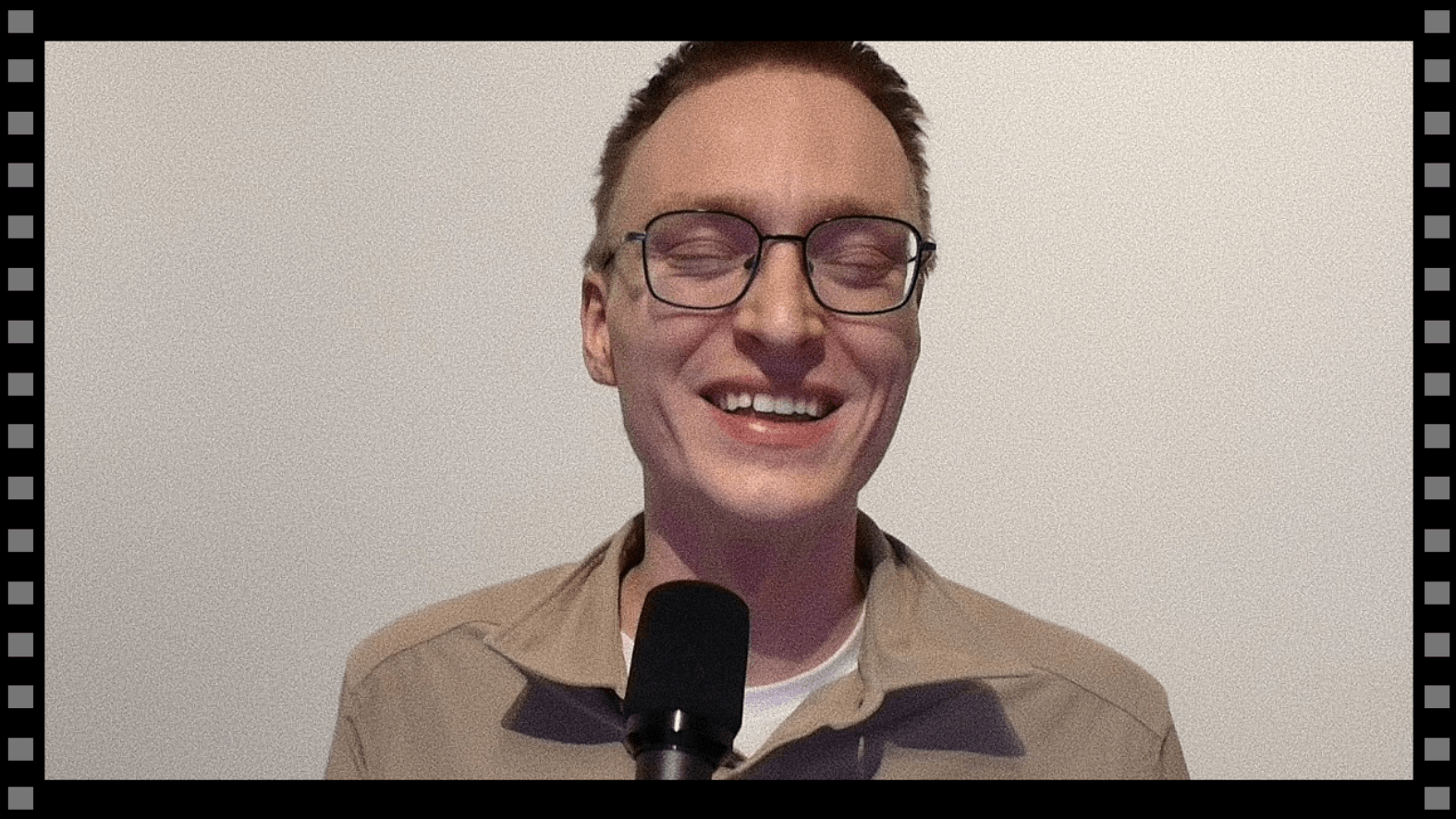 Damion laughing on camera, video grain effect, as if recorded tape